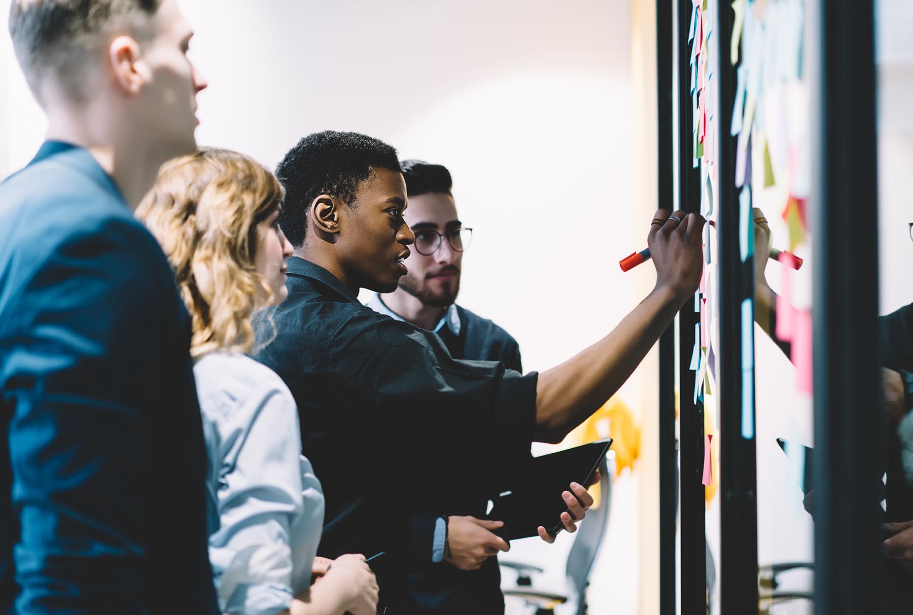 Group of people working around a board